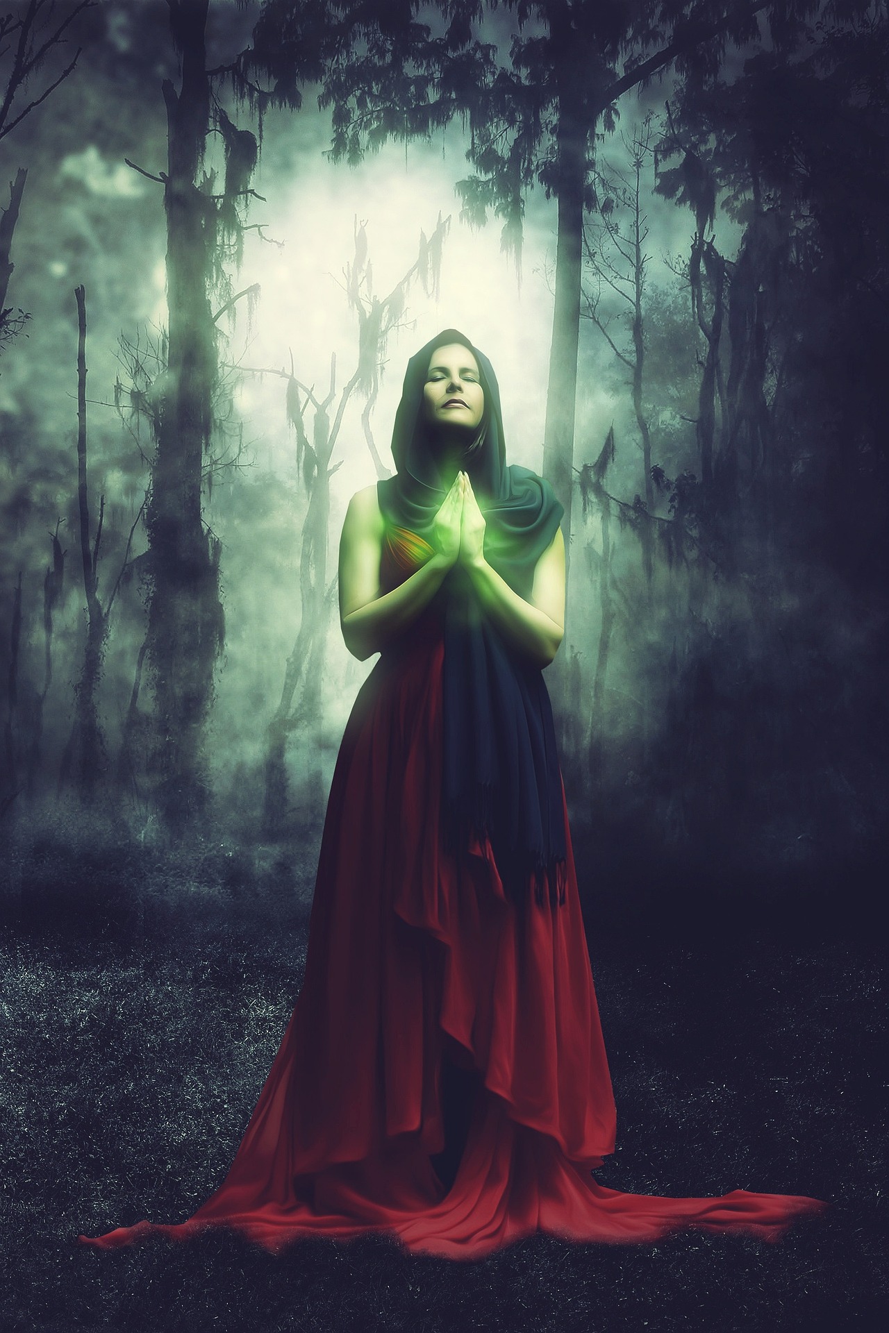 Woman with magic in her hands, praying in the woods