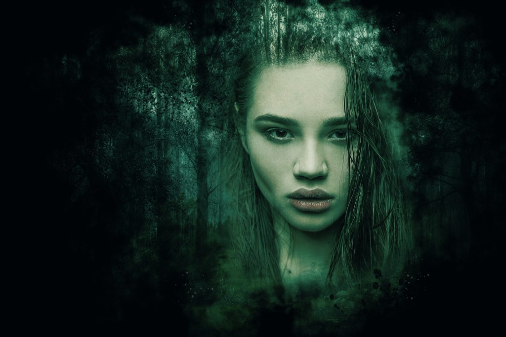 A girl's face surrounded by a forest backdrop and a black border