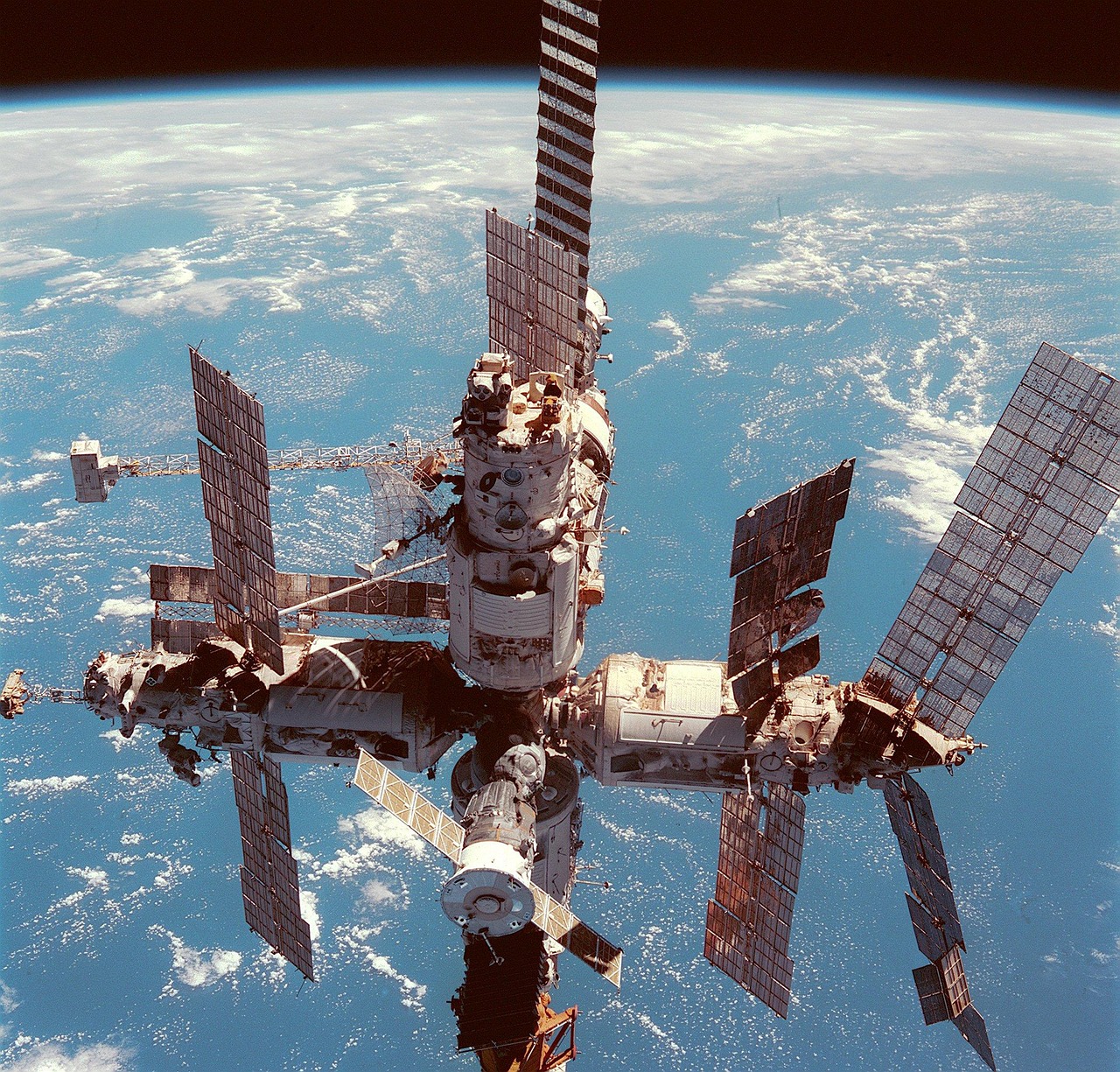 Futuristic space station orbiting a blue planet