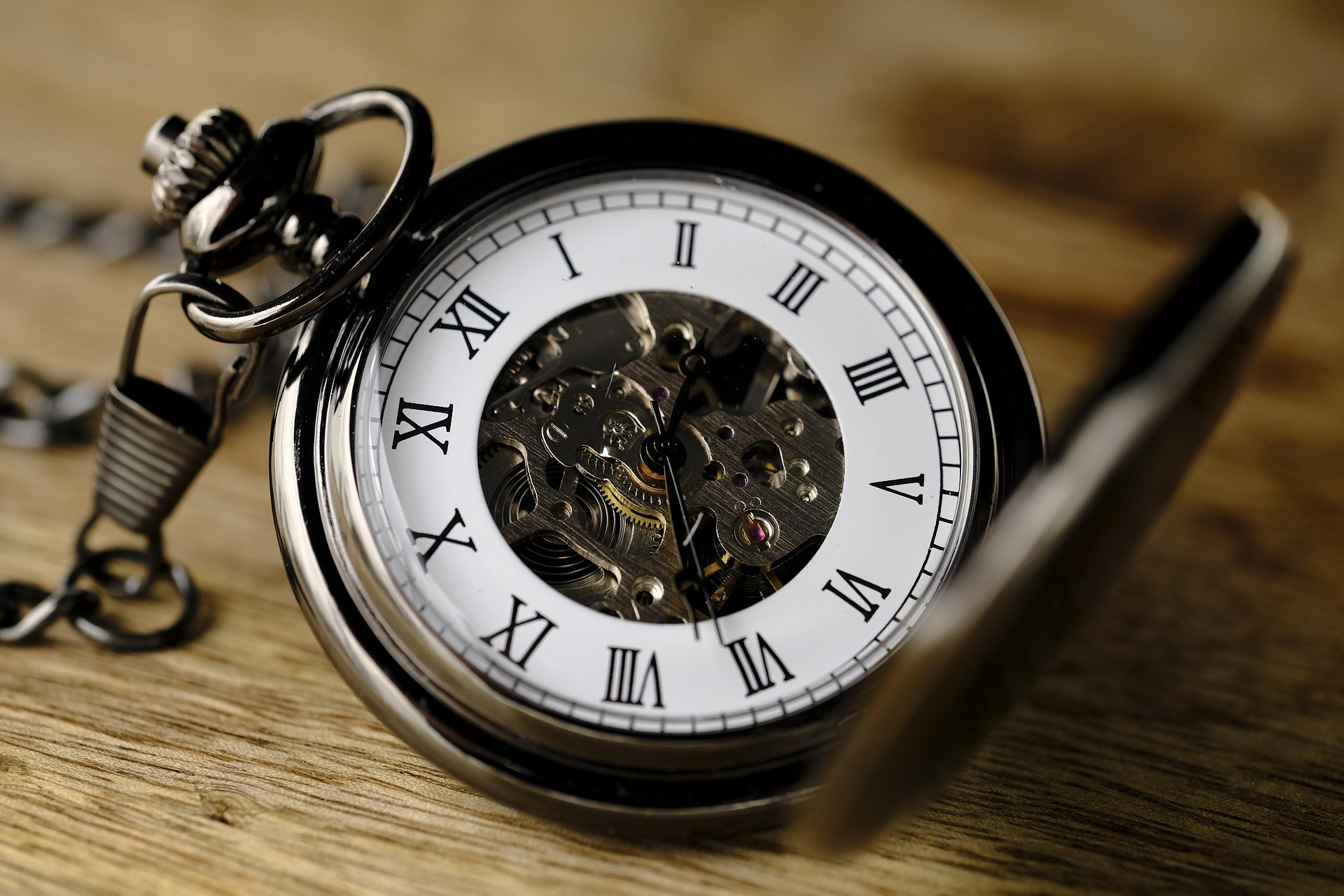 Antique pocket watch with the cover open, revealing the clock face